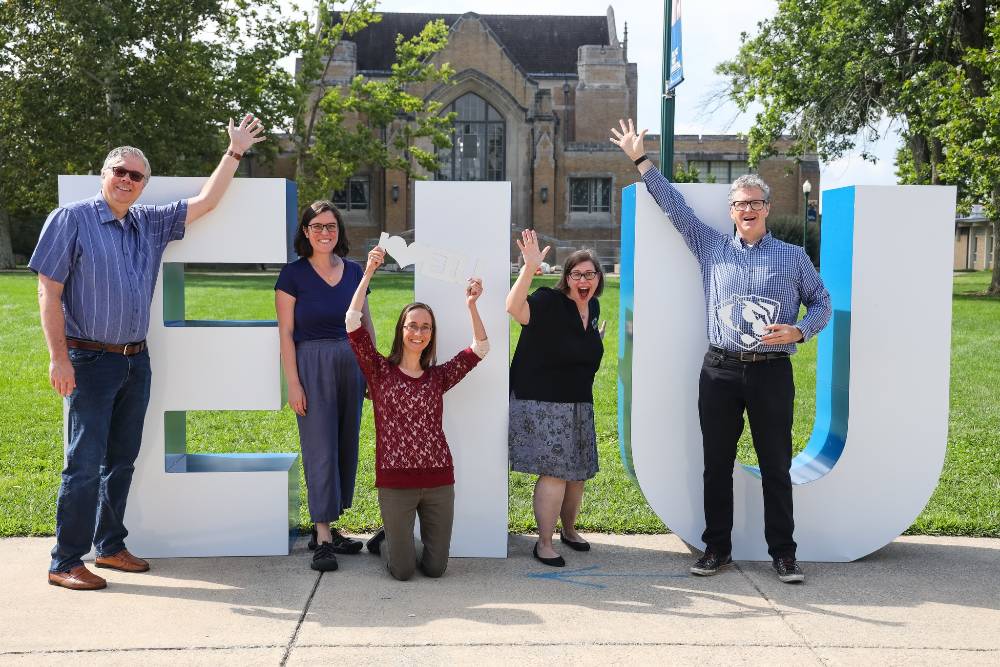 Librarians stand by large E I U letters