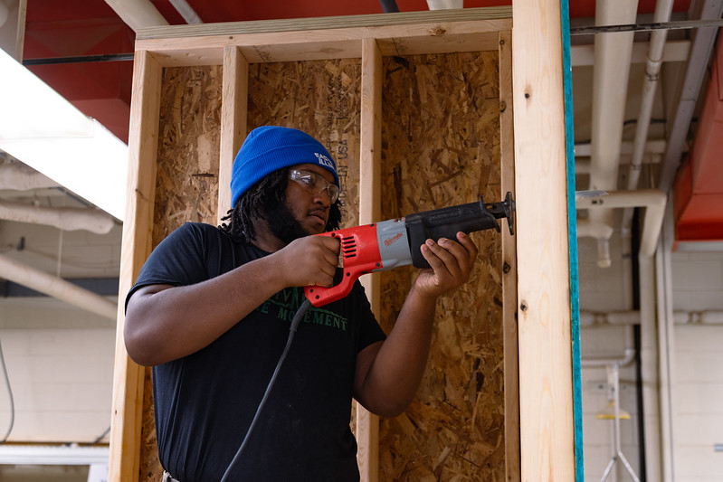 student with nail gun