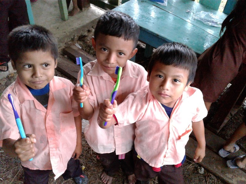 three boys with toothbrushes