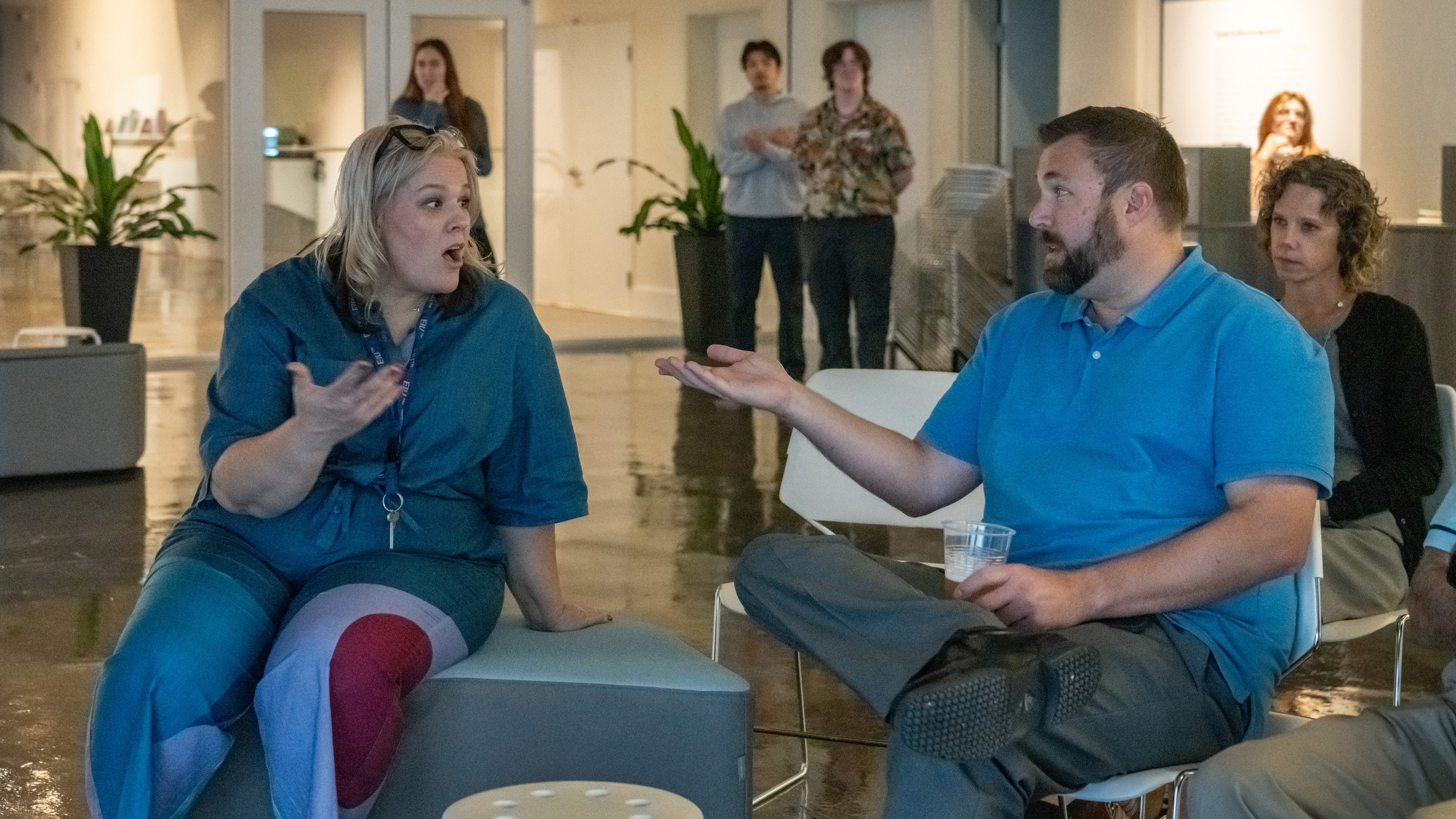 two faculty members discuss at a co-lab